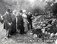 Queen Mary with group at Chelsea Flower Show. Date: 1913.